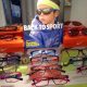 Child wearing sporty sunglasses for kids, surrounded by colorful frames and sports-themed display.