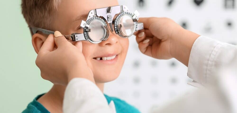 Smiling child undergoing eye test.